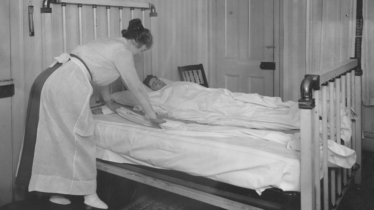 nurse changing sheets