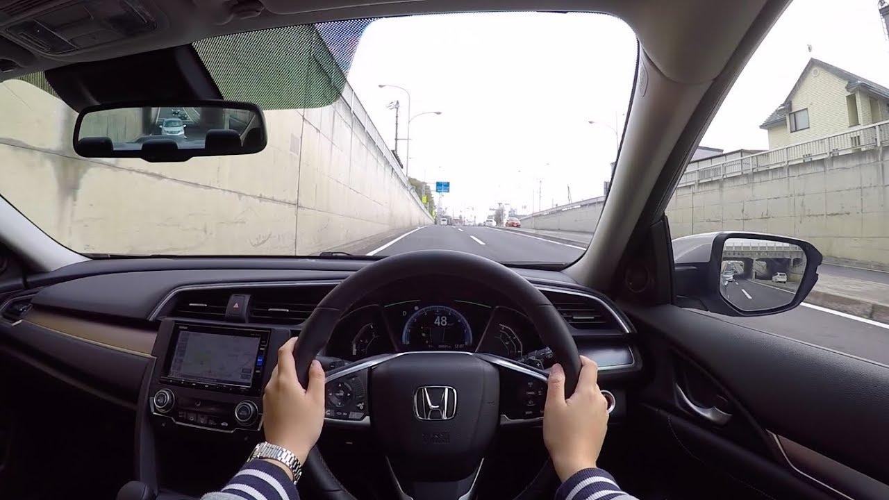 A driver driving a Honda car