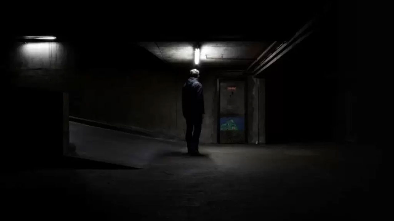 man standing in the dark
