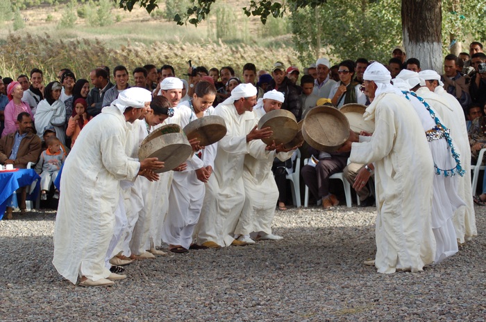 Amazigh people dancing with flutes and drums