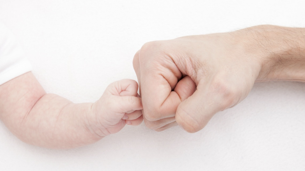 Why are babies born with fist movements?
